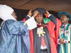 Governor Akpabio being decorated by the Chancellor of Enugu State University Science and Technology