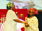 Wife of the Akwa Ibom State Governor, Unoma Akpabio presenting Nigerian Hero Award to Mrs. Elizabeth Akande