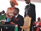 Akwa Ibom State Deputy Governor, His Excellency Obong Nsima Ekere, signs the oath register after taking the oath of office administered by the Chief Judge of Akwa Ibom State, Justice Idongesit Ntemisua, while his wife watches, at the Uyo Stadium on 29th May, 2011